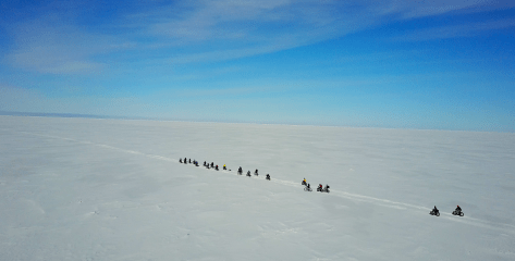 Done - side view of bikers in line riding out to camp cropped